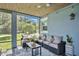 Relaxing screened porch with comfy seating and view of backyard at 1317 Spring Lake Ter, Ocoee, FL 34761