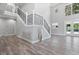 Modern staircase with metal railings and hardwood floors at 1317 Spring Lake Ter, Ocoee, FL 34761