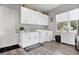 Bright laundry room with white cabinets and a washer and dryer at 1317 Spring Lake Ter, Ocoee, FL 34761