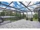 Relaxing screened balcony overlooking lake with seating area at 1317 Spring Lake Ter, Ocoee, FL 34761