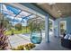 Relaxing pool area with screened enclosure, comfortable seating, and a hanging chair at 1317 Spring Lake Ter, Ocoee, FL 34761