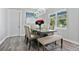 Elegant dining room with a large table, bench seating, and modern light fixture at 1317 Spring Lake Ter, Ocoee, FL 34761