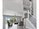 Spacious living room with high ceilings, gray sofas, and large windows at 1317 Spring Lake Ter, Ocoee, FL 34761