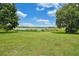 Scenic lakefront property with grassy yard and boat at 1317 Spring Lake Ter, Ocoee, FL 34761