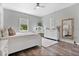Elegant bedroom with white furniture and large mirror at 1317 Spring Lake Ter, Ocoee, FL 34761