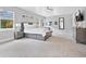Bright main bedroom featuring a king-size bed and large windows at 1317 Spring Lake Ter, Ocoee, FL 34761