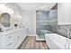 Elegant bathroom with double vanity, soaking tub, and walk-in shower at 1317 Spring Lake Ter, Ocoee, FL 34761