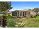 Home exterior showcasing a screened-in porch and patio at 9656 Sw 93Rd Loop, Ocala, FL 34481