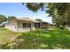 View of the house exterior from the side, showing a large backyard at 9656 Sw 93Rd Loop, Ocala, FL 34481