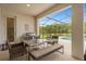 Covered patio with pool, grill, table, and comfortable seating at 3951 Oakville Ave, Kissimmee, FL 34741