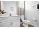 Bathroom with white vanity, toilet and striped wall at 3951 Oakville Ave, Kissimmee, FL 34741