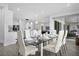 Open dining area with glass table and chairs, offering a view of the living room and backyard at 3951 Oakville Ave, Kissimmee, FL 34741