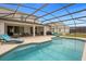 Inviting pool area with covered lanai, lounge chairs, and outdoor seating at 3951 Oakville Ave, Kissimmee, FL 34741