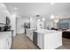 Spacious kitchen featuring white cabinets, a large island, and stainless steel appliances at 3951 Oakville Ave, Kissimmee, FL 34741