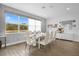 Elegant dining room with glass table, neutral chairs, and a view of the backyard at 3951 Oakville Ave, Kissimmee, FL 34741