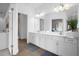 Double vanity bathroom with white cabinets and a modern design at 3951 Oakville Ave, Kissimmee, FL 34741