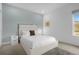 Modern bedroom with a white upholstered bed and window at 3951 Oakville Ave, Kissimmee, FL 34741