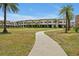 Paved pathway meanders through a grassy area, showcasing the community's landscaping at 3112 Rockefeller Way, Kissimmee, FL 34747