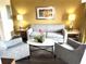 Comfortable living room with gray sofa and armchairs at 12521 Floridays Resort Dr # 302F, Orlando, FL 32821