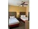 Second bedroom with two double beds and ceiling fan at 12521 Floridays Resort Dr # 302F, Orlando, FL 32821