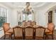 Bright dining room with a large table, chandelier, and access to the backyard at 7411 Gathering Ct, Reunion, FL 34747