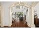 Elegant entryway with hardwood floors and arched doorway at 7411 Gathering Ct, Reunion, FL 34747