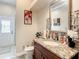 Well-appointed bathroom with granite vanity and decorative tile at 16300 Johns Lake Rd, Clermont, FL 34711