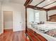 Spacious bedroom with hardwood floors and a large four-poster bed at 16300 Johns Lake Rd, Clermont, FL 34711