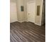 Simple bedroom with wood-look floors and two doors at 824 Camargo Way # 106, Altamonte Springs, FL 32714