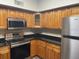 Well-equipped kitchen with ample cabinetry and granite countertops at 824 Camargo Way # 106, Altamonte Springs, FL 32714