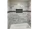 Renovated bathroom with gray marble tile and a new bathtub at 824 Camargo Way # 106, Altamonte Springs, FL 32714