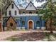 Unique blue and white home with stone accents and a wooden front door at 13857 Marine Dr, Orlando, FL 32832