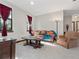 Cozy living room with leather sofa and armchairs, coffee table, and large windows at 13857 Marine Dr, Orlando, FL 32832