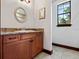 Well-appointed bathroom with brown vanity and tile flooring at 13857 Marine Dr, Orlando, FL 32832