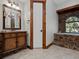 Rustic bathroom with stone bathtub and wooden vanity at 13857 Marine Dr, Orlando, FL 32832