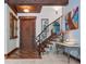 Elegant entryway with wood floors, stone staircase, and a beautiful wood door at 13857 Marine Dr, Orlando, FL 32832
