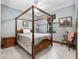 Charming bedroom with wooden four-poster bed and tile floors at 13857 Marine Dr, Orlando, FL 32832