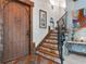 Entryway featuring a rustic wood door and a stone staircase with an ornate railing at 13857 Marine Dr, Orlando, FL 32832