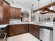 Kitchen boasts dark wood cabinets, granite countertops, and stainless steel appliances at 13857 Marine Dr, Orlando, FL 32832