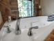 Close up of a luxurious soaking tub with stone surround at 13857 Marine Dr, Orlando, FL 32832