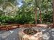 Stone fire pit nestled in a lush backyard setting at 13857 Marine Dr, Orlando, FL 32832