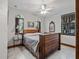 Bedroom with wooden bed frame, tile floors, and a tranquil atmosphere at 13857 Marine Dr, Orlando, FL 32832