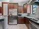 Modern kitchen with stainless steel appliances and ample wood cabinetry at 13857 Marine Dr, Orlando, FL 32832