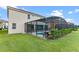 Home with a screened pool and lanai, surrounded by lush landscaping at 6032 Broad Oak Dr, Davenport, FL 33837