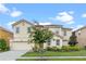 Two-story house with a well-manicured lawn and driveway at 6032 Broad Oak Dr, Davenport, FL 33837