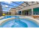 Screened pool and spa with lounge chairs at 6032 Broad Oak Dr, Davenport, FL 33837