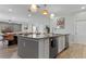 Modern kitchen with island, stainless steel appliances, and breakfast bar at 6032 Broad Oak Dr, Davenport, FL 33837