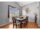 Dining room with hardwood floors, a table set for dinner, and large window at 2570 Amaya Ter, Lake Mary, FL 32746