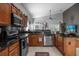 Kitchen features dark wood cabinets, granite countertops, and stainless steel appliances at 2570 Amaya Ter, Lake Mary, FL 32746
