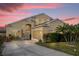 Two-story house with a beige exterior, landscaped yard, and a two-car garage at 2570 Amaya Ter, Lake Mary, FL 32746